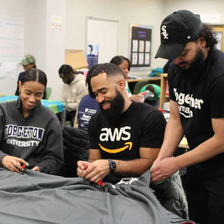 group of people smiling and volunteering
