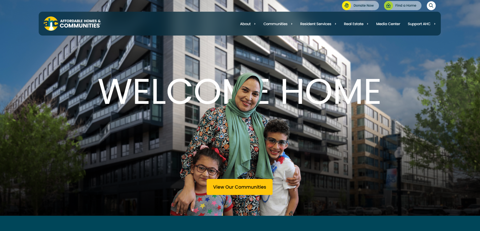 A smiling woman in a headscarf stands with two young children in front of a modern apartment building, highlighting how Arlington County Invests in Goodwill Redevelopment. The words “WELCOME HOME” and a yellow “View Our Communities” button are displayed.