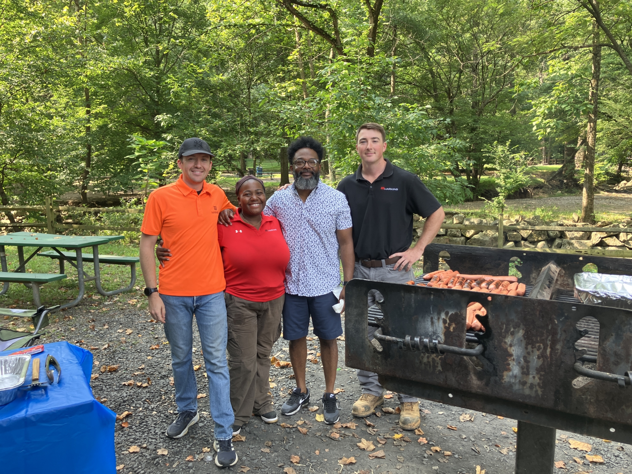 Harkins builders helping at field day. A group of men at a barbecue