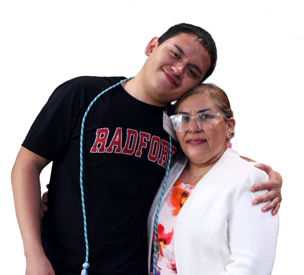 A young man in a Radford T-shirt and honor cord smiles with his arm around an older woman in glasses and a white blazer. Both look happy, celebrating achievements that reflect the spirit of Affordable Homes & Communities.